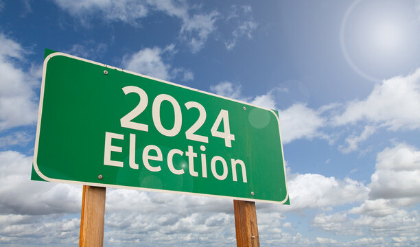 2024 Election Just Ahead Green Road Sign Over Clouds and Blue Sky.
