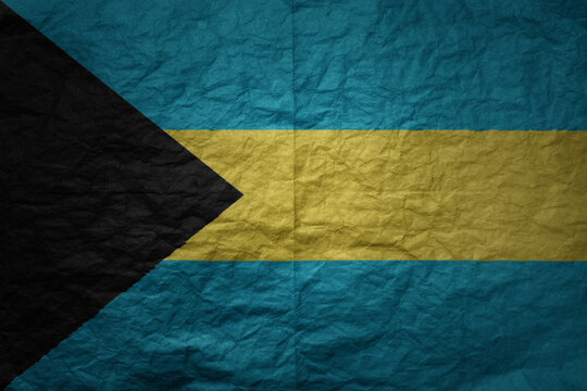 big national flag of bahamas on a grunge old paper texture background