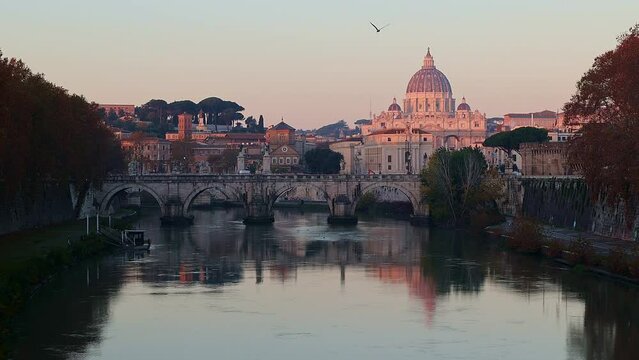View of St. Peter's Basilica in Vatican, Tiber River and Aelian Bridge in early morning skyline at sunrise, idyll, Rome, Italy. Video filmed handheld. High quality FullHD footage