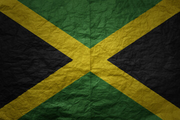 big national flag of jamaica on a grunge old paper texture background