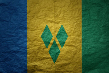 big national flag of saint vincent and the grenadines on a grunge old paper texture background