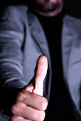 Close-up of a thumbs-up gesture in focus