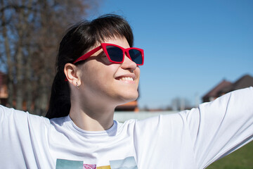 Portrait of a young woman in red sunglasses	