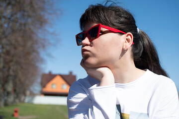 Portrait of a young woman in red sunglasses	