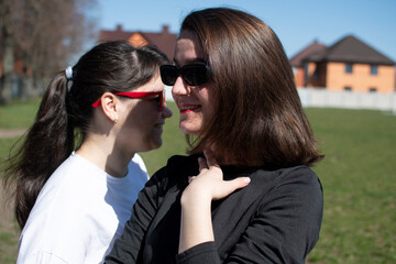 Close up portrait of a two young women in sunglasses	