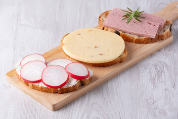 Sandwiches with radishes, cottage cheese, cheese and sausage