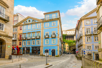 Colorful buildings with shops and cafes in the old town Ribeira district with a tunnel going under the Viewpoint of the Church of São Lourenço, in Porto Portugal.