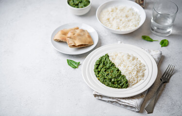 Spinach dahl with rice in a plate - 782518073