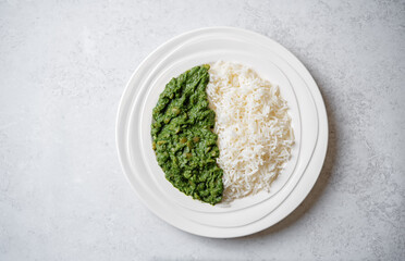 Spinach dahl with rice in a plate - 782518077