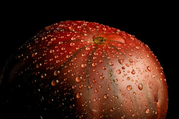 Raindrops on ripe heirloom tomato