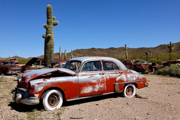 mid century classic cars abandoned in the desert junkyard