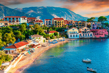 Assos, Kefalonia, Greece. Colorful houses and turquoise colored bay of a village on an idyllic...