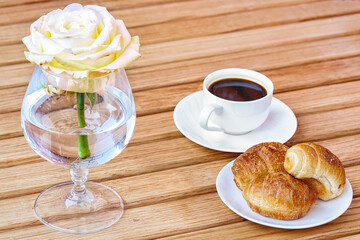 Amazinf aromatic coffee and croissants on a plate.