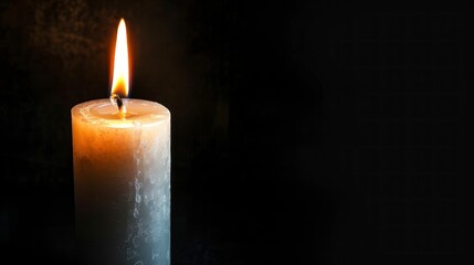 white candle lit on a black background giving light in high resolution and high quality HD