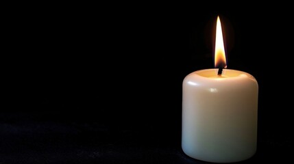 Fototapeta na wymiar cute lit candle on black background in high resolution and high quality