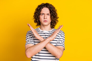 Photo portrait of pretty teen male crossed hands show stop gesture dressed stylish striped outfit...