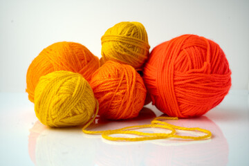 Orange Yarn wool balls on a white background 