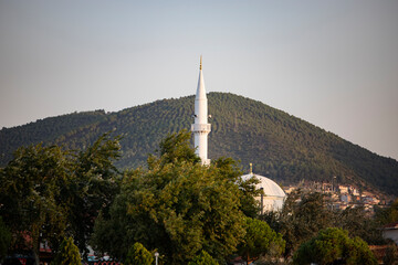 Mosque on the hill in the city. Minaret of the mosque in the city of Ören, Turkey 