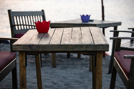 Restaurant on the beach. Table and chairs on the beach. Wooden table and chairs on the beach