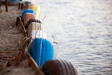 Colorful car tires on the beach. Selective focus with shallow depth of field. Close-up image with...