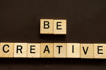 Be Creative Message Spelled Out With Wooden Blocks on a Dark Background