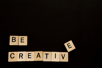 A Wooden Block With The Word Be Creative - Written On It.
