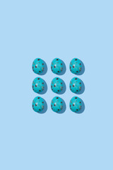 Pattern of beautiful blue chicken eggs for Easter on  blue background, top view