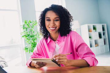 Photo of pretty young girl make notes write notebook entrepreneur wear trendy pink outfit modern interior indoors office workstation