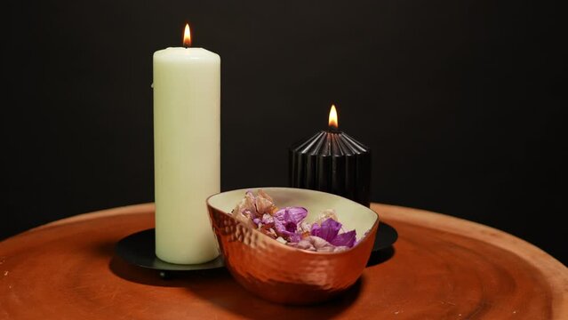 Burning magic candles with gold bowl of dry flower petals. Ritual scene and magical witchcraft atmosphere. Magical occult esoteric ritual. Halloween rite background.