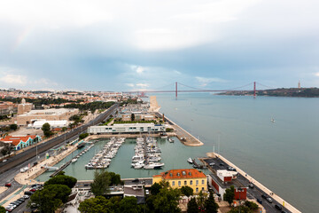 Yacht parking on the coast of the Atlantic Ocean in the suburbs of Lisbon, Portugal. Marina in Belem. Vasco da Gama bridge on background 