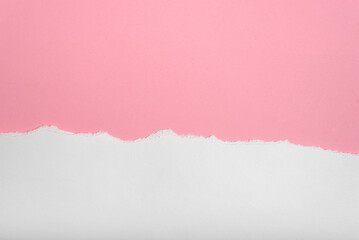 Torn white paper on pink paper background. Blank space for text.
