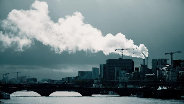 Smoke stacks and tower cranes within the cityscape of Paris, France