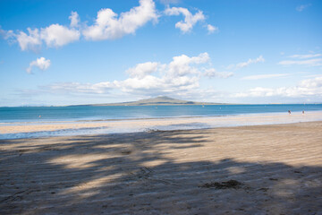Beach overlooking a volcano located in Takapuna, New Zealand. 