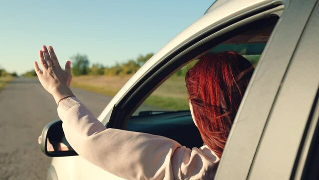 girl rides car with her hand out window, enjoying picturesque landscape sunset, cheerful girl smiling, windy breeze from window cars, cars summer day, hand sun, happy girl car window waving her hand