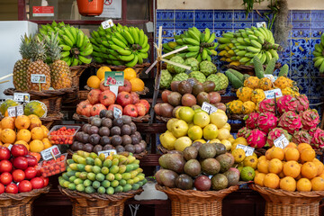 Mounds of Colorful Fruits - Bananas, Avocados, Dragon Fruit, Tomatoes, in an Outdoor Market in Funchal, Madeira, Portugal  - 782596872