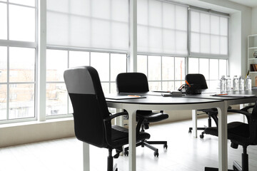 Interior of modern office with table prepared for meeting