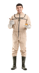 Obraz premium Male beekeeper with honey and spoons on white background