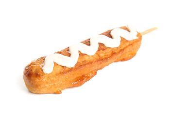 Tasty corn dog with mayonnaise on white background