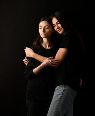 beautiful portrait of a couple of girls on a black background - 782617087