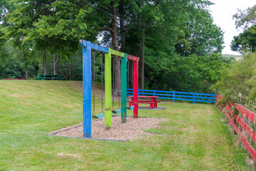 Fototapeta na wymiar Colorful Wooden Frames for Swings, Adding a Splash of Joyful Hues to the Playground