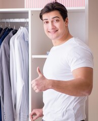Young man businessman getting dressed for work - 782623055