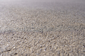 Fototapeta na wymiar A close up of a grey concrete surface with a lot of small rocks