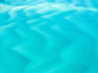 Aerial view of blue sea surface. Calm blue waters. Panorama of blue clean ocean water surface. 