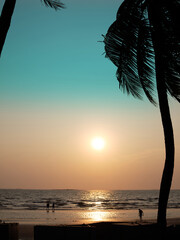 BANGSAEN,THAILAND 2024 , Silhouette Coconut trees at sunset in a full length beach. The beach at Bangsaen, Chonburi Province Thailand Concept sunset , summer , holiday