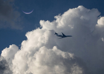 Corporate Jet at Low Altitude with Storm Clouds and Crescent Moon