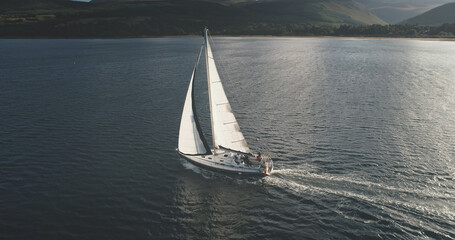 Sun light at sea bay with luxury yacht reflection aerial. Epic passenger sailboat cruise at open...