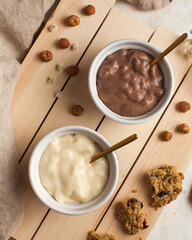 Vanilla and chocolate mousse desserts with golden spoons