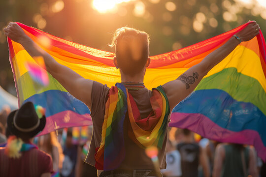 Person Holding Rainbow Flag at Sunset, LGBTQ Pride and Freedom