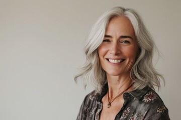 Portrait of a beautiful senior woman with white hair smiling at the camera - Powered by Adobe