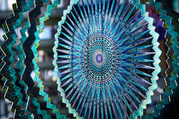 Kaleidoscope image of blue, purple, teal patterns and abstract shapes in a colorful graphic design